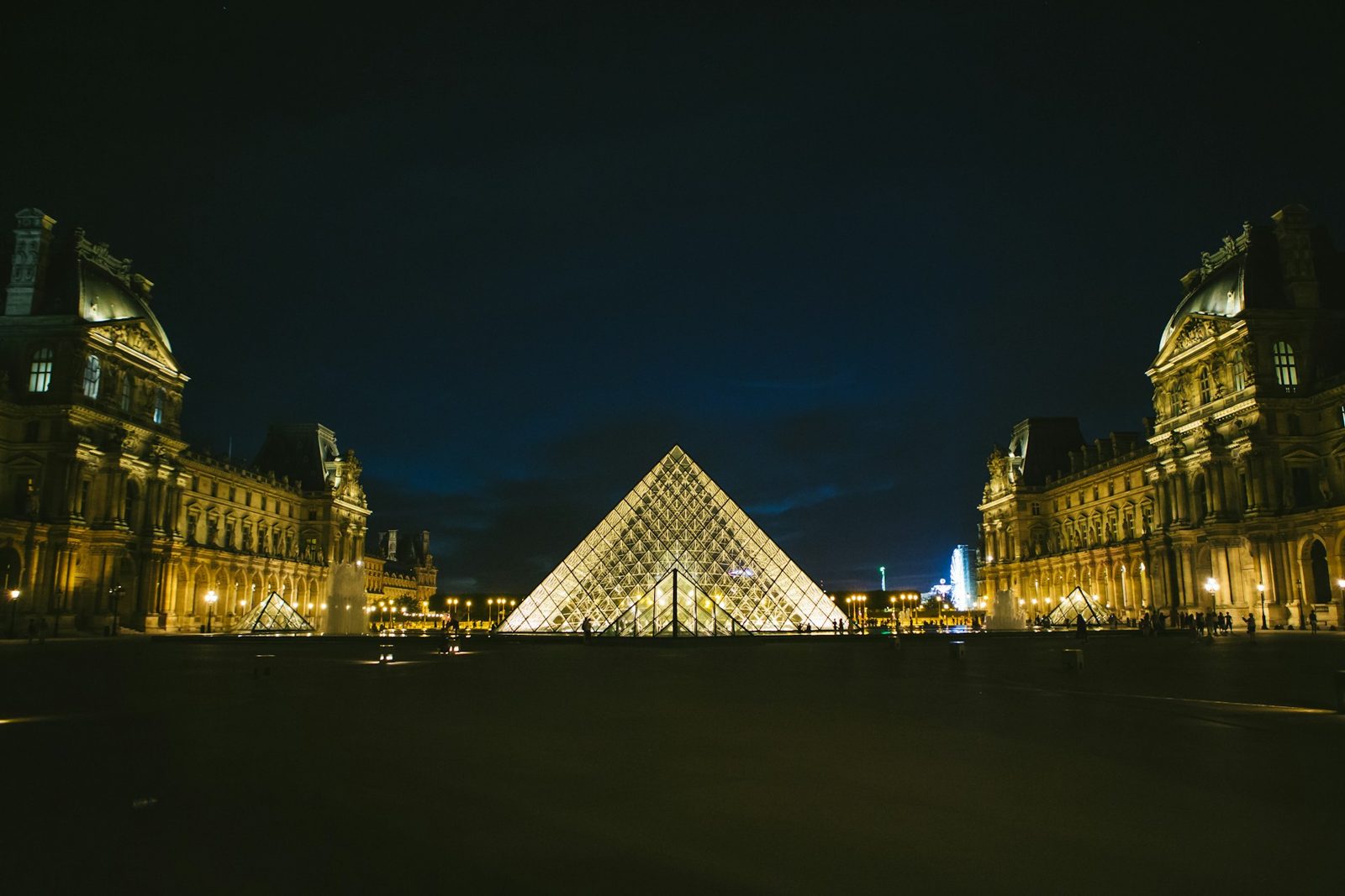 The Louvre pyramid lit up at night